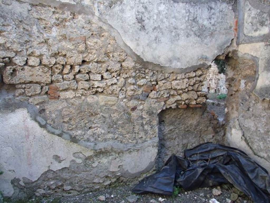 IX.9.d Pompeii. March 2009. Room 2. Cupboard. North wall with holes for shelving supports.