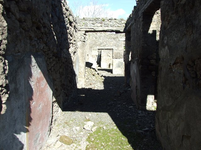 IX.9.e Pompeii. March 2009. Room 17, east wall, with doorway and window to room 16, the light-yard. 
