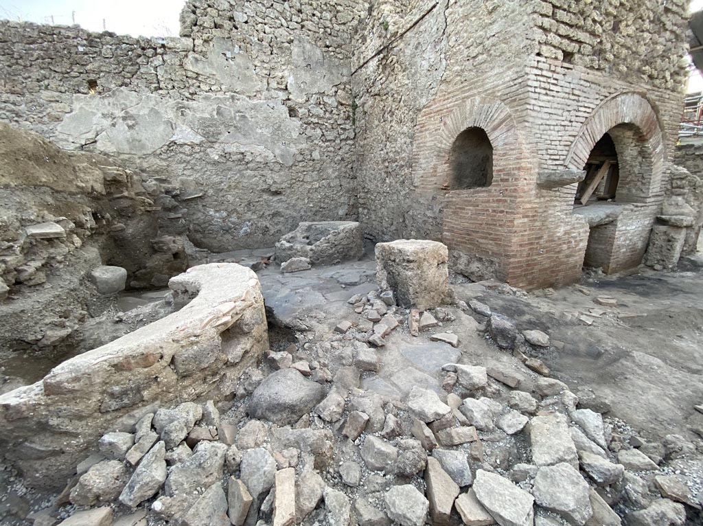 IX.10.1 Pompeii. December 2023. Bakery room 7.
The bakery is ascribed to a building phase, which we are led to place in the post-seismic period of 62 AD on the basis of the wall evidence.
When creating the production plant, care was taken to supply drinking water via a pipe that originates from the nearby water tower located at the north-east corner of IX.10, reaches the house at number 2 where the laundry is located, runs diagonally across the house at number 1 and finally flows into a rectangular basin in room (7).
Photograph © Parco Archeologico di Pompei.
See Pompeii E-Journal 08, 08.12.2023, p. 87, figg. 2 and 3. Download: PAP e-journals 2023 collection volumes 01-09