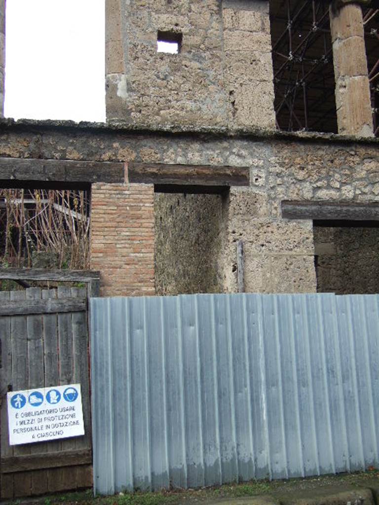IX.12.2 Pompeii. December 2005. Entrance, leading to stairs to upper floor. According to Boyce, on the south side (front) pilaster, visible on the right of the photo, was a painting of Mercury. This was on the pilaster to the right of the entrance to the stairs leading from the street to the upper floor. Mercury was shown with a serpent at his feet coiled around an omphalos; the painting on the opposite pilaster had disappeared.  Not. Scavi, 1912, 144f.  See Boyce G. K., 1937. Corpus of the Lararia of Pompeii. Rome: MAAR 14. (p.112, no.27)  See Fr�hlich, T., 1991. Lararien und Fassadenbilder in den Vesuvst�dten. Mainz: von Zabern. (F69)
According to Varone and Stefani, found on the pilaster, on the left, between IX.12.1 and IX.12.2 were CIL IV 7896 and 7897. On the right of the doorway, also found were CIL IV 7898, 7900 and 7903. In the photo on page 443, a plaster-cast of the stairs in situ was made, and can be seen. See Varone, A. and Stefani, G., 2009. Titulorum Pictorum Pompeianorum, Rome: L�erma di Bretschneider, (p.441-449)
According to Epigraphik-Datenbank Clauss/Slaby (See www.manfredclauss.de), these read as �
Ampliatum 
aed(ilem)         [CIL IV 7896] 
Vettiu[m 3]       [CIL IV 7897]
Valentem 
filium  aed(ilem)  o(ro)  v(os)  f(aciatis)       [CIL IV 7898]
Pansam  aed(ilem) 
Amandus  sacerdos  rog(at)         [CIL IV 7900]
Balbum  aed(ilem)  d(ignum)  r(ei)  p(ublicae) 
[3]fus  facit       [CIL IV 7903]
According to Della Corte, he thought this was a textrina, of an unknown Rufus, who was mentioned in an electoral recommendation. This was CIL IV 7903, found on the pilaster to the right of the stairs. Not least interesting were the plaster-casts of the stairs, of the wall and door of the latrine, and of the entrance door to a room to the north. All plaster-casts that were destroyed in the bombing. See Della Corte, M., 1965.  Case ed Abitanti di Pompei. Napoli: Fausto Fiorentino. (p. 321-2)
