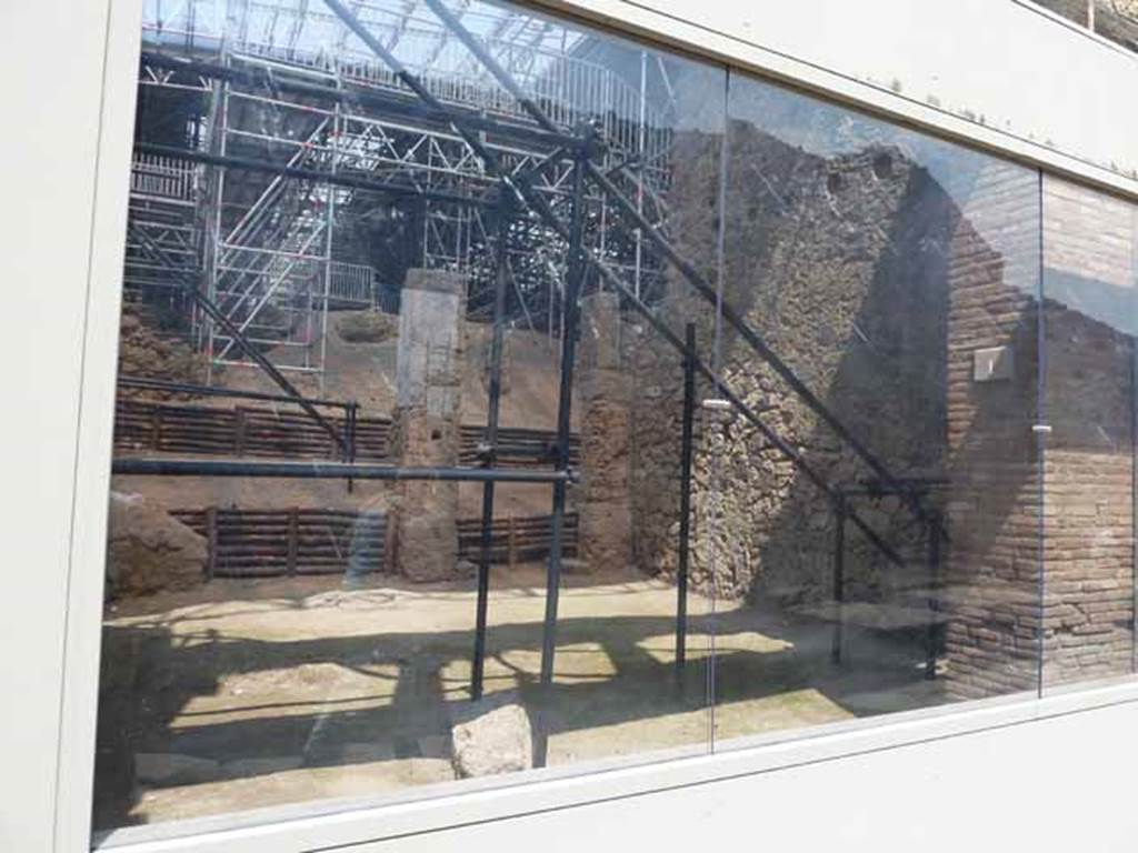 IX.12.2 Pompeii. May 2010. Looking through glass front across IX.12.1 to site of stairs, against east wall, on right.