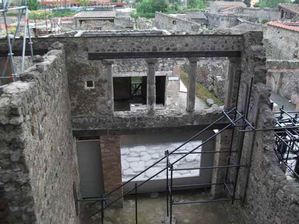 IX.12.2 Pompeii. May 2010. Doorway to stairs to upper floor, on left, and IX.12.1, lower rooms.
Looking south towards and across Via dell’Abbondanza. The upper wall, on the left, would be the east wall of the large “front” room on the upper floor. The north wall would have been approximately along the line of the lower photo. Found on this north wall, and left in situ, opposite the three windows, were the remains of the painting of Bellerophon and flying Pegasus receiving the letter of Proetus, here called “Chryses”. On the west wall, only a few fragments of another painting of the liberation of Andromeda were also found in this room, showing the names of Andromeda and Perseus, painted near the remaining fragments of the figures.
See Della Corte, M., 1965. Case ed Abitanti di Pompei. Napoli: Fausto Fiorentino. (p.321).
Spinazzola, V. Pompei, alla luce degli Scavi Nuovi di Via dell’Abbondanza (Anni 1910-1923), Vol.2, p.720, fig.693-7.
(Note: Della Corte wrote that the painting was left in situ, we do not know where it is now, perhaps in the deposits! When did the north wall disappear, perhaps just “wear and tear” perhaps the 1980 earthquake – another mystery to solve).