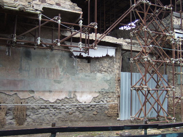IX.12.7 Pompeii. May 2010. The street entrance to IX.12.7 is on the left hand side. Looking south from above room 8 in IX.12.6.