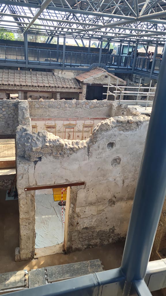 IX.12.9 Pompeii. June 2024. 
Doorway into PAP room 18, looking east towards peristyle 5, with monumental gateway 7.   
Photo courtesy of Giuseppe Ciaramella.
.
