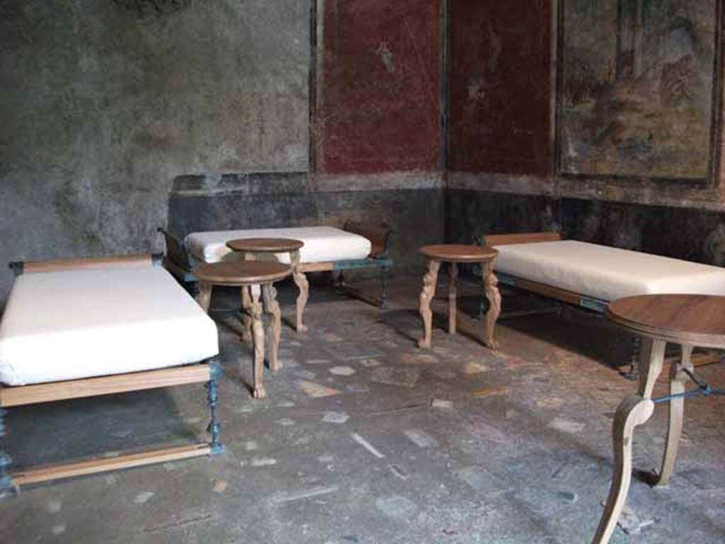 IX.13.1-3 Pompeii. May 2010. Room 13, three reproduction couches and tables.