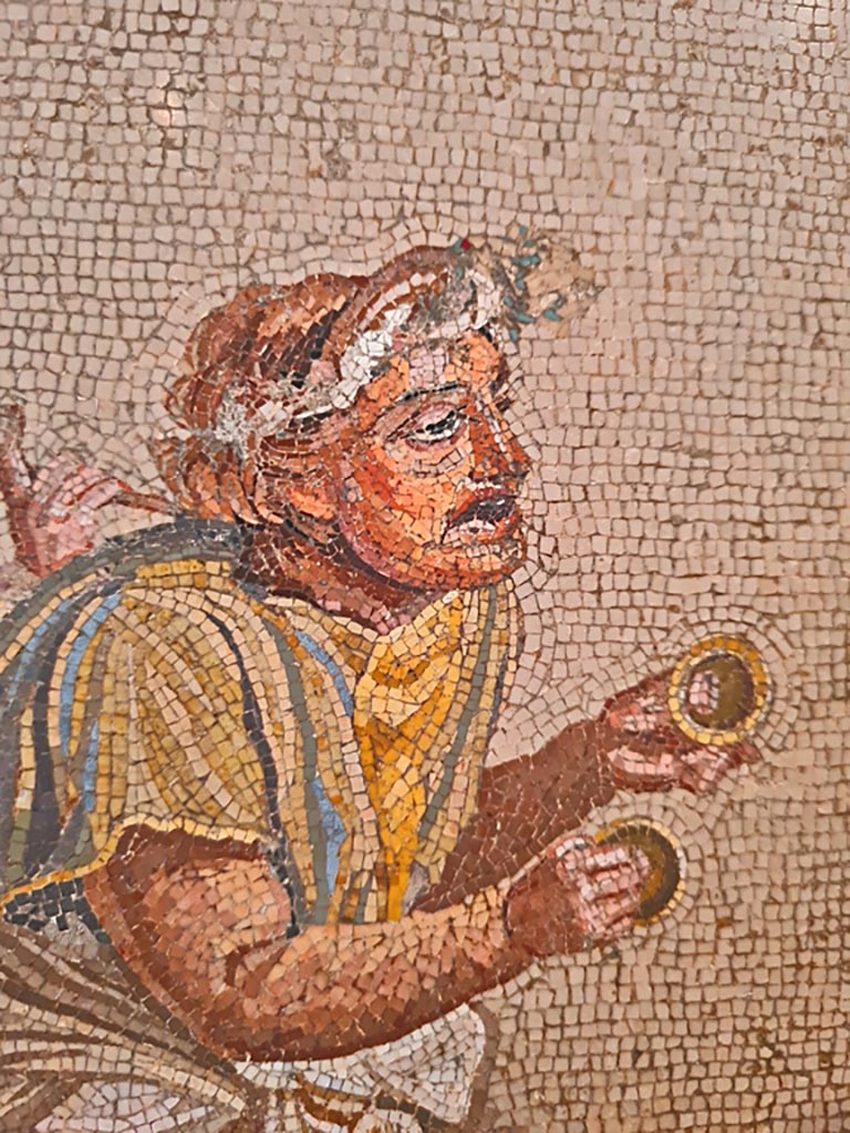 HGW06 Pompeii. Found on 8th April 1763. Ambiente 13 of Villa of Cicero.
Detail from mosaic of a Group of Street Musicians showing a musician playing cymbals.
Now in Naples Archaeological Museum. Inventory number 9985.
Photo courtesy of Giuseppe Ciaramella. September 2024.