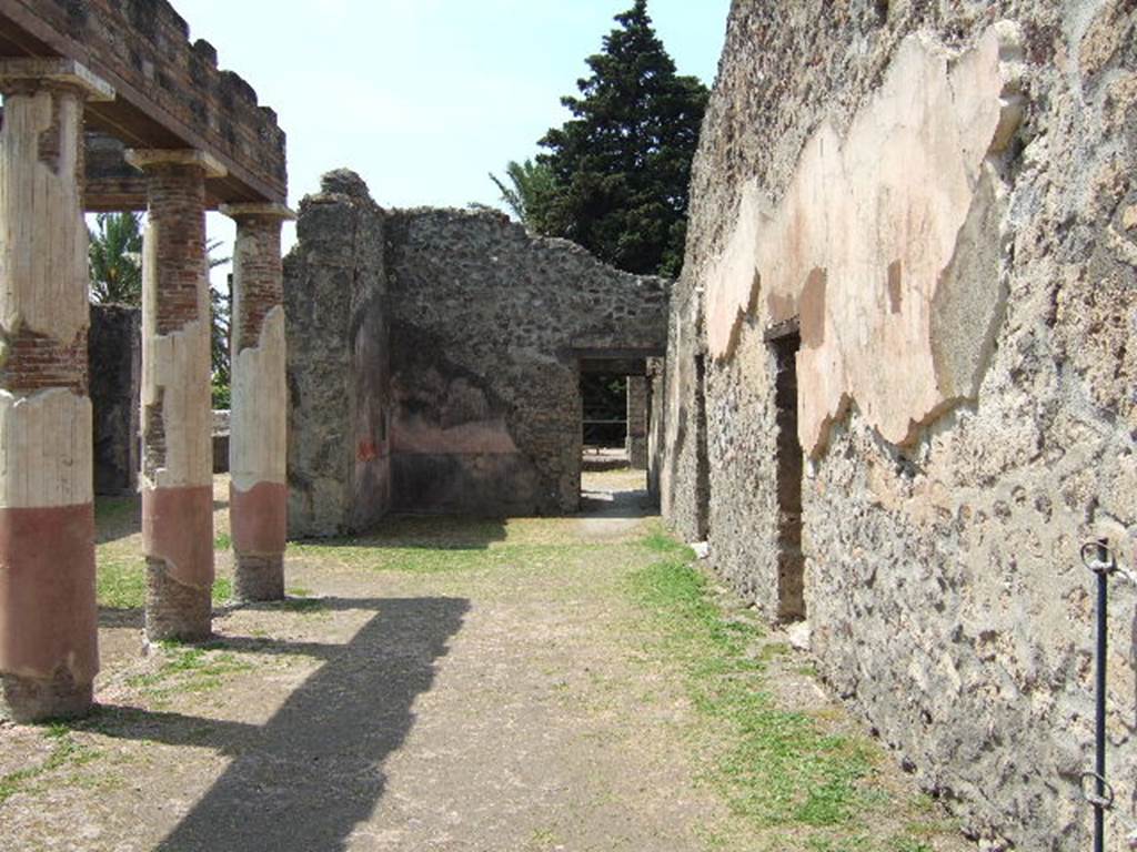 HGW24 Pompeii. May 2006. Looking west along north side of peristyle towards ala.
(Fontaine, north side of courtyard portico was numbered as 2a, the doorway (on right) is actually a niche near to which La Vega No.45, and No.8 were found.
From PAH, addendum, p.127 – (see No.45 below, on the plan by La Vega this was found along this side of the front peristyle).
Relazione delle antichita, che si vanno ritrovando nella masseria del sig. D. Giovanni Milano parsonaro, che si era principiata al di 14 Febbraro 1771. (Report of Antiquities found .....)
“No.45. Nella stessa date. Si sono trovate due scive di bronzo, ed una grappa delle stesse.”
“No.45. Of the same date. Two bronze parts of chest, possibly a lock or lock-bolt, and a hook (or reinforcing piece) of the same were found."
PAH addendum, p.158 - 6 Giugno 1772.
Altra bocca di cisterna simile. Vasca in mezzo al cortile, rivestita di marmo; no.43, 44, 45 pianta di La Vega.