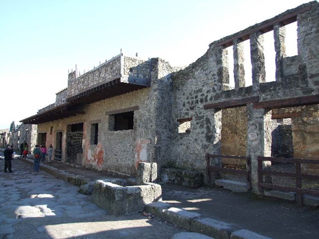 Via dell’ Abbondanza, south side. December 2006. Looking east from I.12.1.  