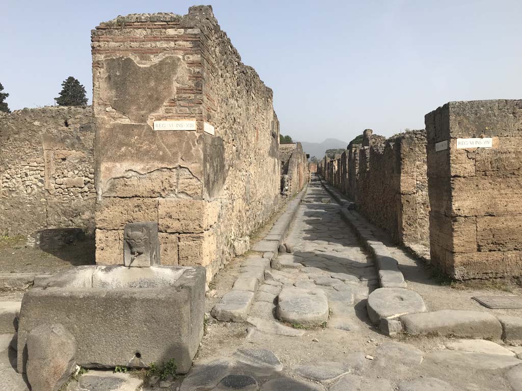 Vicolo dei Vettii between VI.13 and VI.14. April 2019. Looking north from Via della Fortuna.
The fountain is outside VI.13.7. Photo courtesy of Rick Bauer.