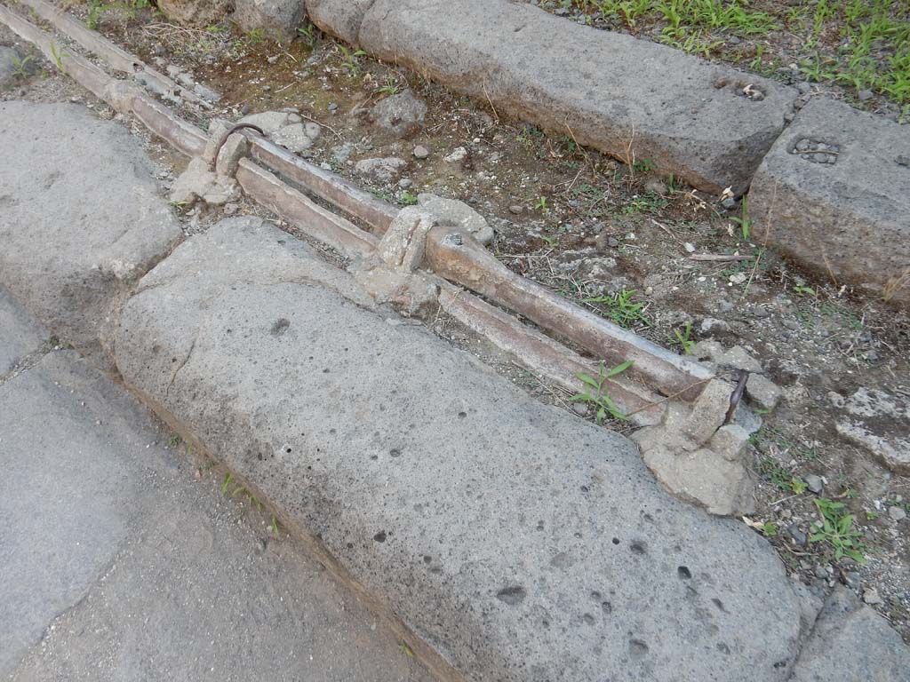 Vicolo dei Vettii, Pompeii, west side. June 2019. Detail of lead water pipes in pavement outside VI.13.13.
Photo courtesy of Buzz Ferebee.