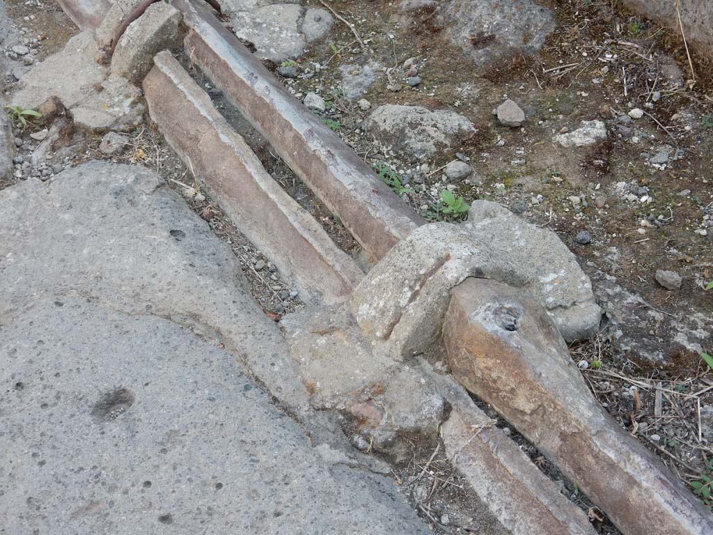 Vicolo dei Vettii, Pompeii, west side. June 2019. Detail of lead pipes in pavement outside VI.13.13.
Photo courtesy of Buzz Ferebee.