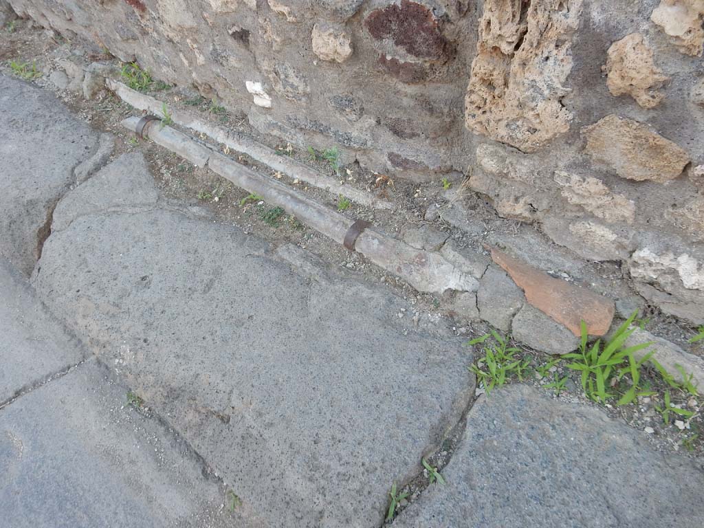Vicolo dei Vettii, Pompeii, west side. June 2019. Detail of lead pipes in pavement outside VI.13.13.
Photo courtesy of Buzz Ferebee.