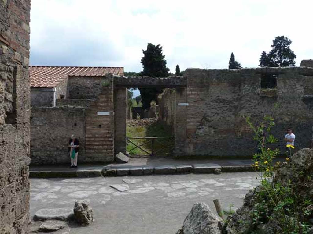 Via dell�Abbondanza, south side. May 2010. Looking across junction to Vicolo della Venere, between II.3 and II.2