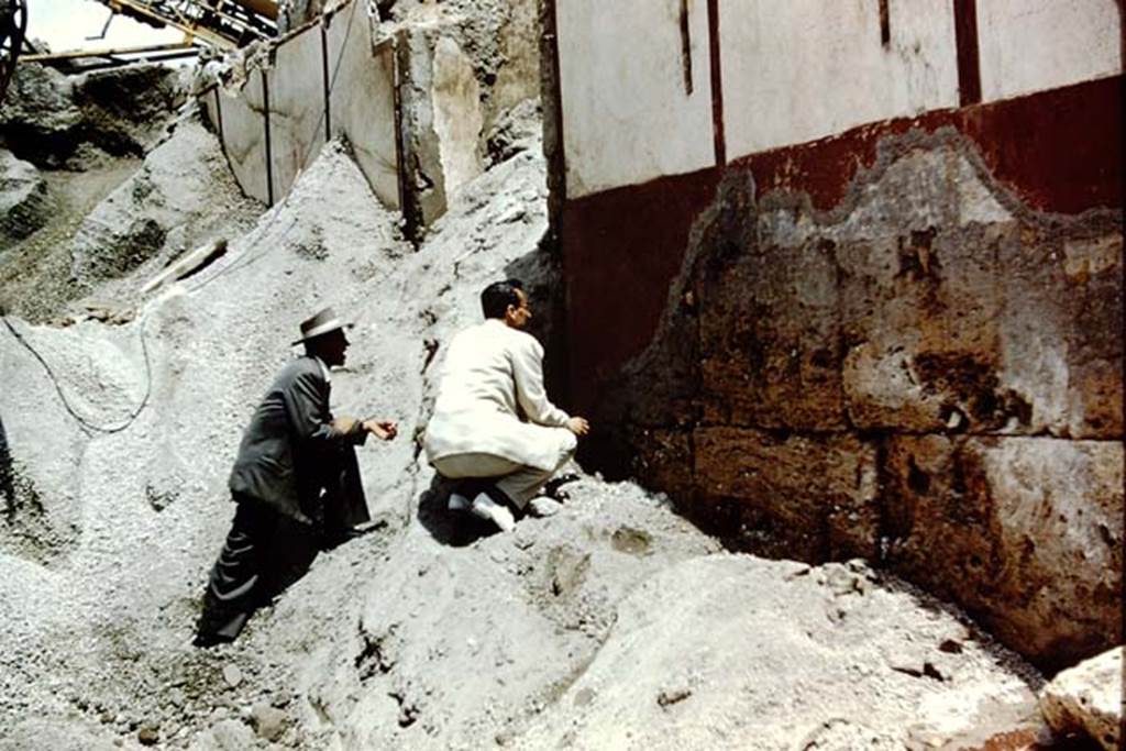 Vicolo di Ifigenia, east side, Pompeii. 1961. Studying the wall on the south side of doorway at III.4.e. Photo by Stanley A. Jashemski.
Source: The Wilhelmina and Stanley A. Jashemski archive in the University of Maryland Library, Special Collections (See collection page) and made available under the Creative Commons Attribution-Non Commercial License v.4. See Licence and use details.
J61f0300