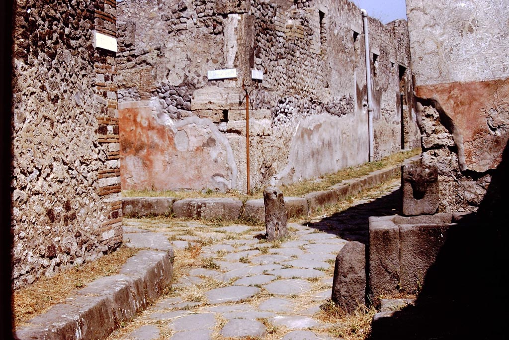 Vicolo di Tesmo, Pompeii. 1972.
Looking north, with Vicolo di Balbo, on the left, and IX.7, on the right at rear of fountain. Photo by Stanley A. Jashemski.
Source: The Wilhelmina and Stanley A. Jashemski archive in the University of Maryland Library, Special Collections (See collection page) and made available under the Creative Commons Attribution-Non-Commercial License v.4. See Licence and use details.
J72f0112