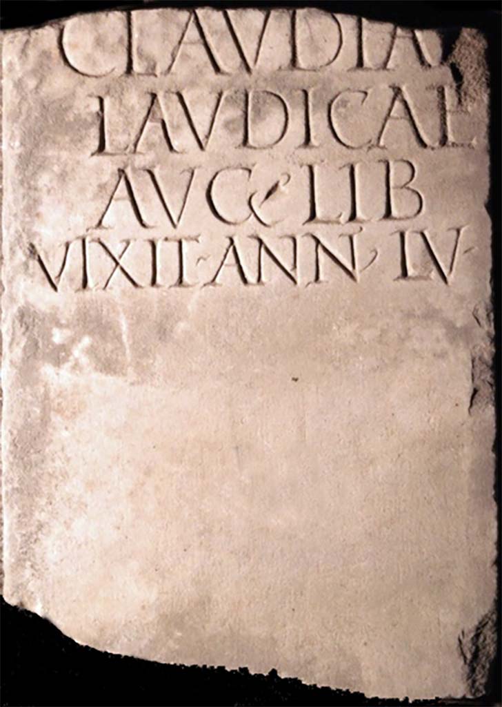 Pompei, Tombe presso la Strada Regia, Fondo Santilli. Found in 1883 or a little earlier. 
Marble columella of Claudiae Laudicae.
Now in Naples Archaeological Museum. Inventory number 123256.
It was 1m high and 0.26m wide, broken at the top and with a circular hole towards the base.
According to Mau, it was found in the Fondo Santilli, around 1883 or a little earlier, more towards the city, immediately south of the road, at the meeting point of the old and the new road.  It may have been from a monument on the opposite side of the ancient road, facing the tomb now discovered.
See Mittheilungen des Kaiserlich Deutschen Archaeologischen Instituts, Roemische Abtheilung, 1894, p. 65.
It bore an inscription already published by Novi and reproduced in Ephemeris Epigraphica. Sogliano published it again and confirmed its authenticity and noted that the manuscript copy of Novi was not exact in the distribution of the lines.
See Ephemeris Epigraphica, Vol. VIII, 1899, p. 87, no. 319.

CLAVDIAE
LAVDICAE
AVG • LIB
VIXIT • ANN • LV •

Claudiae
Laudicae
Aug(usti) lib(ertae)
vixit ann(is) LV

Burial of a freedwoman.
See Notizie degli Scavi di Antichità, 1893, p. 334 no. 13.

Cooley translates this as 

To Claudia Laudica, freedwoman of Augustus. Lived 55 years.       [EE VIII no. 319]

See Cooley, A. and M.G.L., 2004. Pompeii: A Sourcebook. London: Routledge, G35, p. 148.

See also Tutiae Gaiae libertae Licentiae found in the same location in 1894.

