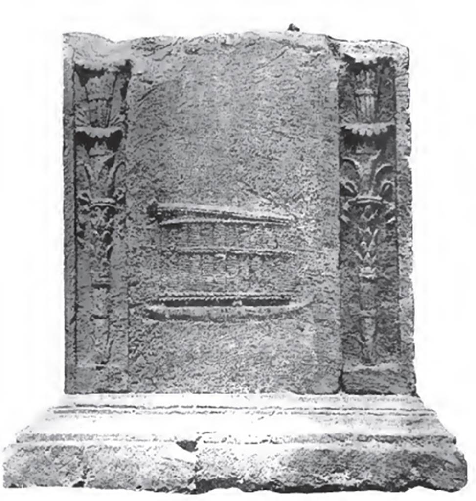 NGH Pompeii. 1910 photo of south side of altar on Schola tomb.
According to Spano, this is a mystical chest, made of rushes, cylindrical, wide, and supported by feet, of which three are visible. 
The head of a snake is lifting the cover. This side is framed by two great torches.
This symbolises that the buried person had been in initiated in life into the mysteries of Dionysus.
See Notizie degli Scavi di Antichit�, 1910, p. 395-6.
