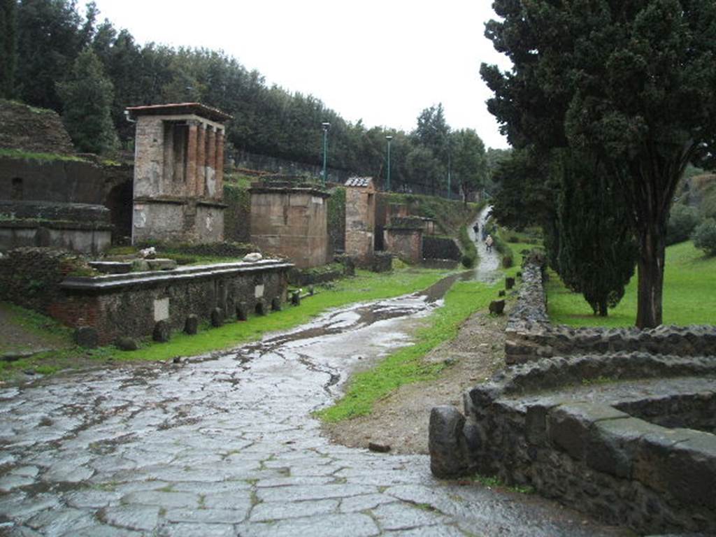 Pompeii Via delle Tombe. December 2004. Tombs on south-west and north-west sides. Looking west from crossroads of Via di Nocera and Via delle Tombe.