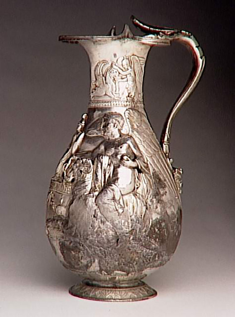 Villa della Pisanella, Boscoreale. Boscoreale Treasure. Oenochoe, silver wine vase with repousse decoration and traces of gilding. Height about 25 cm. Side 2.
On the neck: a winged genius gives water to a griffin. On the body: one victory on a ram, offers incense and an olive branch. Handle terminated at bottom with a head of Silenus crowned with ivy.

Oenocho� du tr�sor de Boscoreale - Vase � vin en argent d�cors repouss�, traces de dorure. Hauteur environ 25 cm. C�t� 2.
Sur le col : un g�nie ail� abreuvant un griffon. Sur la panse: une victoire sur un b�lier, offre de l'encens et un rameau d'olivier. Anse termin� en bas par une t�te de Sil�ne couronn�e de lierre.
Photo � RMN-Grand Palais (mus�e du Louvre) / Herv� Lewandowski.
Now in the Louvre, inventory number BJ 1898.
