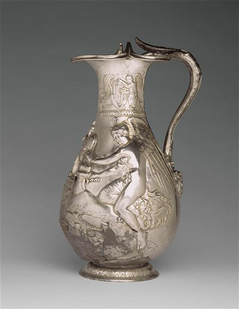 Villa della Pisanella, Boscoreale. Oenochoe of the treasure of Boscoreale - Silver wine vase with repousse decorations, traces of gilding, late 1st century AD - Height about 25 cm. Side 2.
On the collar a winged genius gives water to a griffin. On the body one of two Victories sacrificing a bull on either side of an altar bearing the palladium.

Oenochoe du tr�sor de Boscoreale - Vase � vin en argent d�cors repouss�, traces de dorure, fin du Ier si�cle ap. J.C. - Hauteur environ 25 cm. C�t� 2.
Sur le col un g�nie ail� abreuvant un griffon. Sur la panse l�un des deux Victoires sacrifiant un taureau de part et d'autre d'un autel portant le palladion.

Now in the Louvre, Inventory number BJ 1899.
