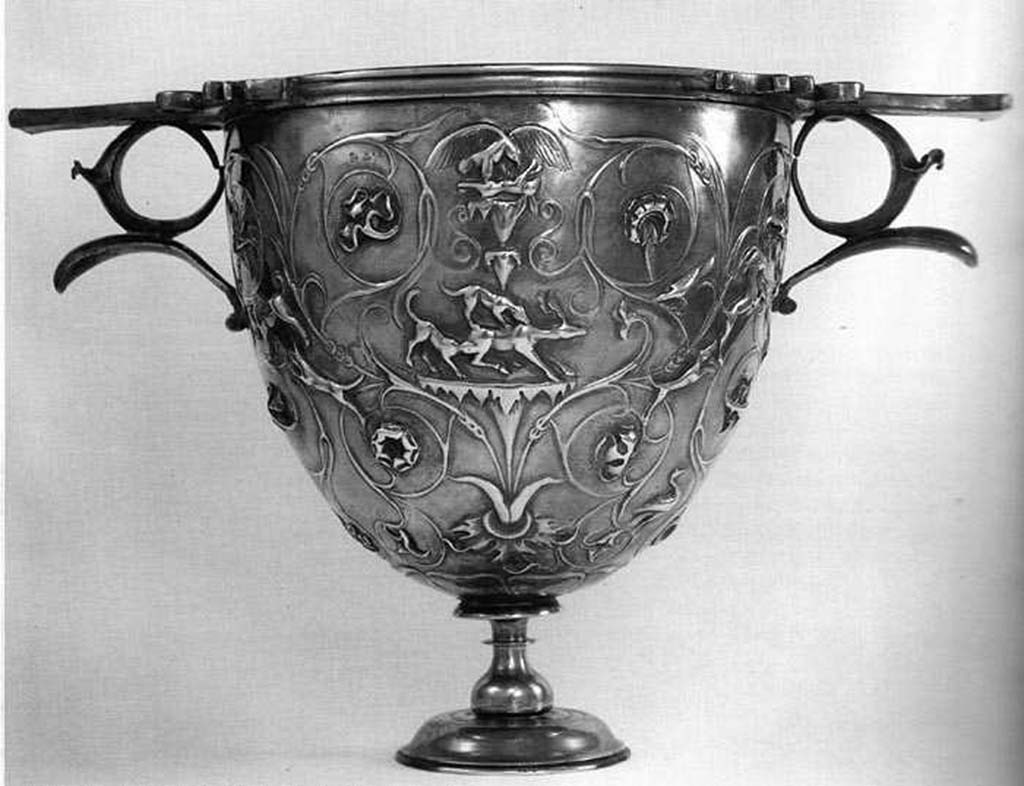 Villa della Pisanella, Boscoreale. Boscoreale silver. One of a pair of silver Cantharus decorated with floral scrolls and animal fights; eagle skinning a hare; dogs attacking a deer.
Vase � m�ler le vin, orn� de rinceaux avec poursuites d'animaux : aigle d�pe�ant un li�vre; chiens for�ant un cerf.
Now in the Louvre, inventory number BJ1907.
Voir/See De Villefosse H., 1899. L'argenterie et bijoux d'or du tr�sor de Boscoreale description des pi�ces conserv�es au Mus�e du Louvre: Monuments et Memories 5 1899 with supplement 1902, pl. IX.
