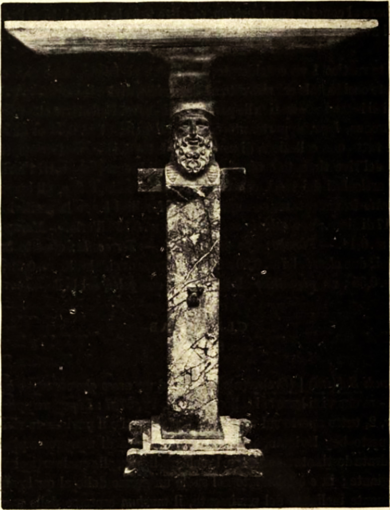 Pompeii, Villa rustica nel Fondo di Antonio Prisco. Marble table.
See Notizie degli Scavi di Antichità, 1921, p. 418, fig. 2.
But a find of more importance was a beautiful marble table.
The marble top of the table 0.75 x0.47m, in “fior di persico” (a rich marble, mottled with red and white) was supported by a monopodium 0.92m high, rising from a simply formed base.
The monopodium was decorated by a herm, at the top of which was a bearded Hermes with a head in “rosso antico” (maroon red marble from Greece), the feet of “giallo antico” (yellow marble from Numidia) and the trunk of “marmo africano”(dark, generally black, marble from Turkey).