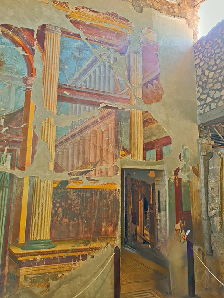 Oplontis Villa of Poppea, October 2023.
Room 15, detail of painted decoration at south end of east wall and doorway to room 14.
Photo courtesy of Giuseppe Ciaramella.