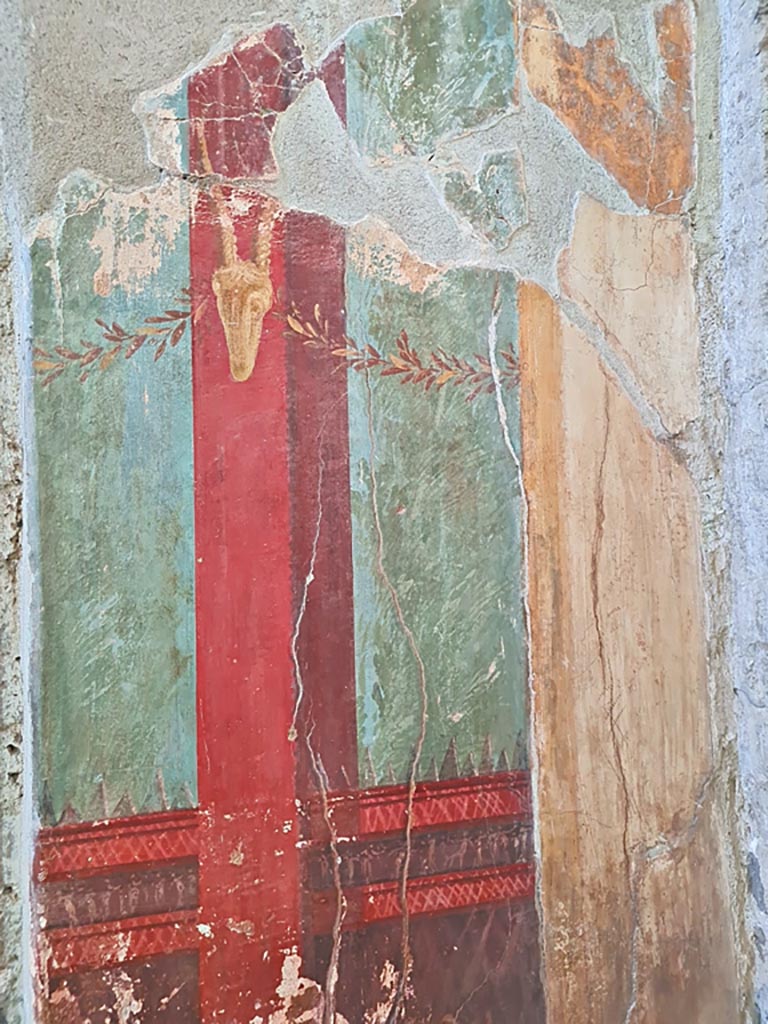 Oplontis Villa of Poppea, October 2023.
Room 15, detail of painted decoration at side of doorway to room 14, in east wall in south-east corner.
Photo courtesy of Giuseppe Ciaramella.