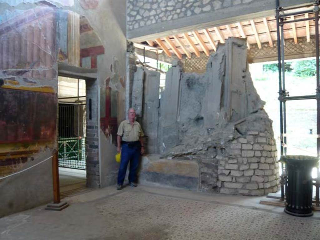 Oplontis, May 2011. Room 15, looking towards south-east corner of the oecus, with Buzz posing to act as a comparison for the size of the window shutters. Photo courtesy of Buzz Ferebee.