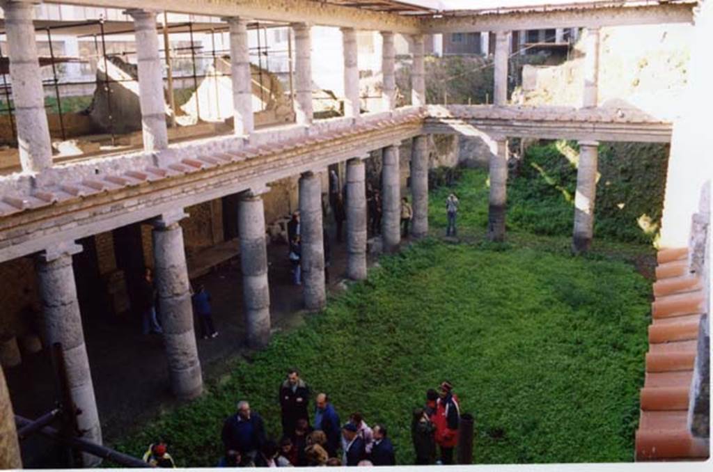 Oplontis, Villa L. Crassius Tertius. March 2005. Looking south-west across courtyard 27 from the upper level.
According to the Soprintendenza, il nucleo centrale dell'edificio è costituito da un porticato a due ordini di colonne doriche in tufo grigio di Nocera.
The core of the building consists of a portico with two rows of Doric columns in grey Tuff from Nocera.
See Villa on the Soprintendenza web site