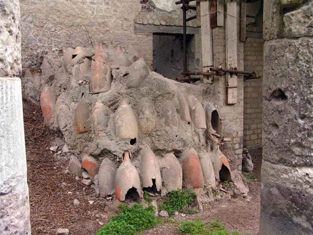 Oplontis, Villa of Lucius Crassius Tertius. March 2005. Room 18bis, west end.
Some of the 400 amphorae found, many stacked upside down.
Photo courtesy of Massimo Gravili.
According to Malandrino there were many washed amphorae inverted for drying.
This showed this villa was inhabited and active at the time of the eruption.
See Malandrino, C., 1981, Sylva Mala II, p. 3-4.