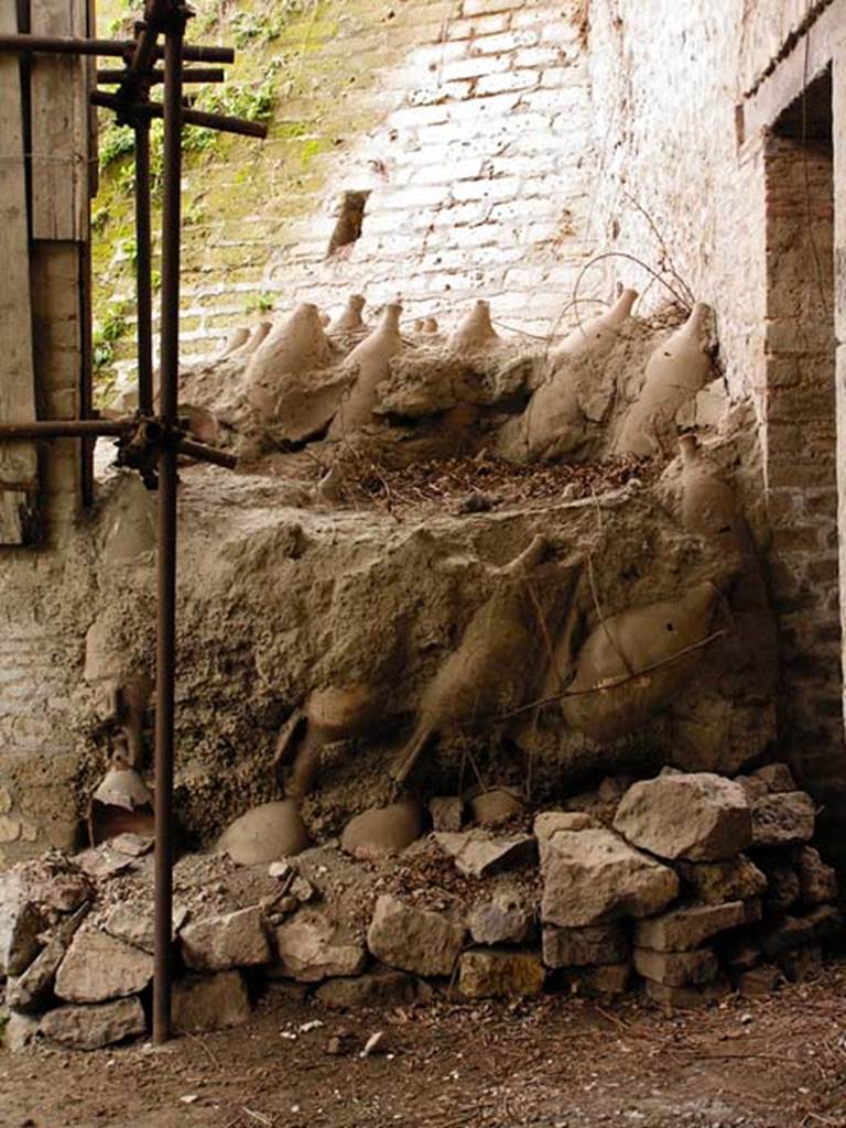 Oplontis, Villa of Lucius Crassius Tertius. March 2005.
Room 18bis Amphorae stacked upside down outside the door of room 17.
Photo courtesy of Massimo Gravili.
In their 2014 season the Oplontis Project undertook the cataloguing of stored materials that remained from previous excavations.
They catalogued some 600 amphora, a significant increase from the 400 previously reported.
See http://www.fastionline.org/excavation/micro_view.php?fst_cd=AIAC_334&curcol=sea_cd-AIAC_5748