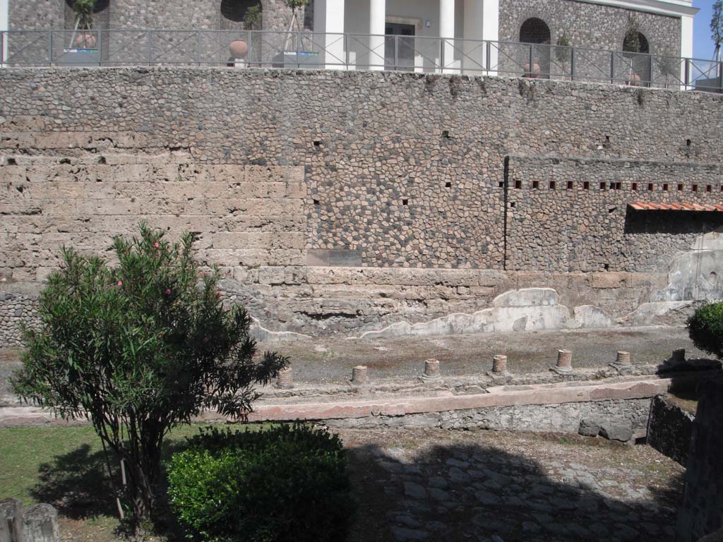 Walls on south side of Porta Marina, Pompeii. June 2012.
Looking east towards Antiquarium, above, and Suburban Villa, below. Photo courtesy of Ivo van der Graaff.
According to Van der Graaf –
“South of the Porta Marina opus incertum superimposed on a few older travertine courses acts as a terrace for the Temple of Venus.
A lonely block of tuff suggests that the masonry replaced an earlier travertine/tuff curtain. The so-called Villa Imperiale (VIII.1.a) enveloped this section of the fortifications in the last first century BCE, covering them with Third Style frescoes and burying the external pomerial street.”
See Van der Graaff, I. (2018). The Fortifications of Pompeii and Ancient Italy. Routledge, (p.117-118, and Note 36).