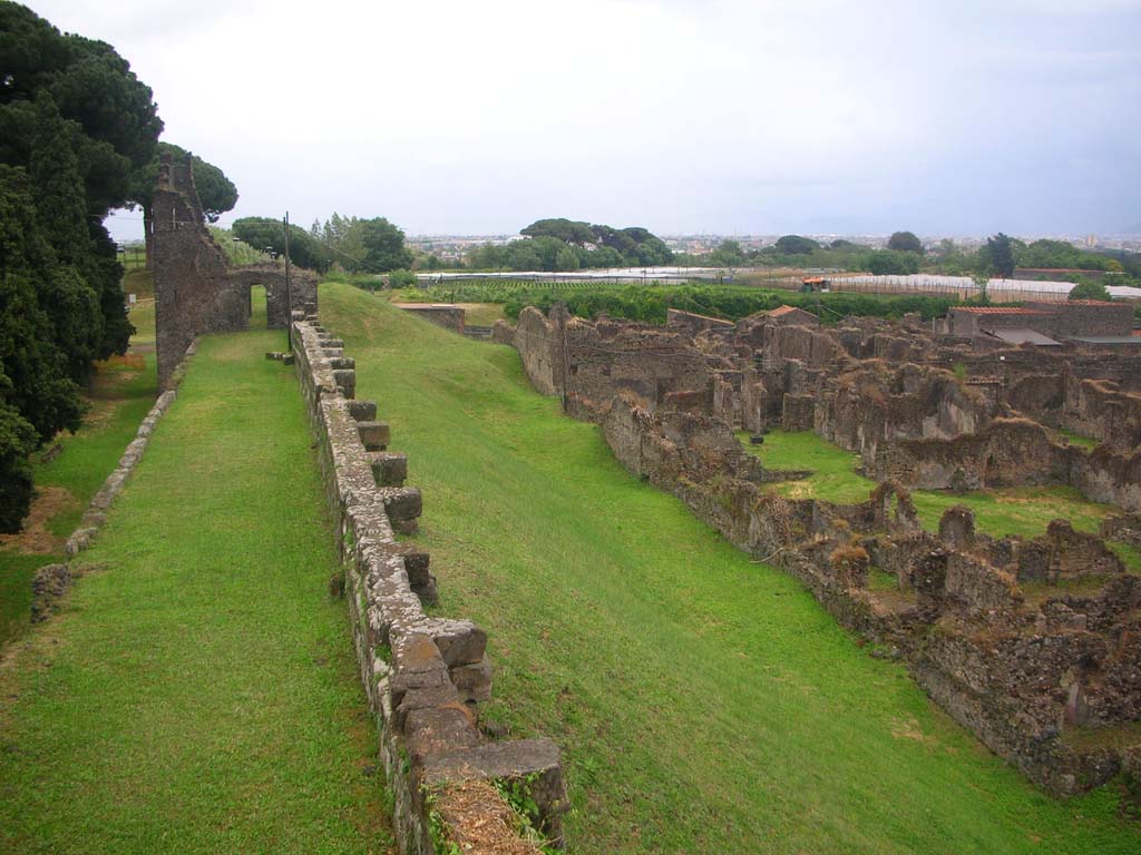 City Walls on north side of Pompeii. May 2010.
Looking east line of walls towards Tower X, with north side of insulas VI.15, and VI.11. Photo courtesy of Ivo van der Graaff.